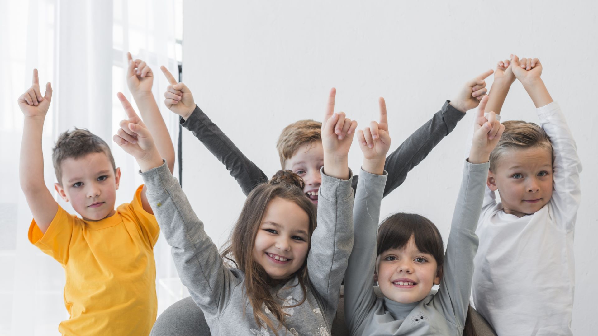 children with their hands up