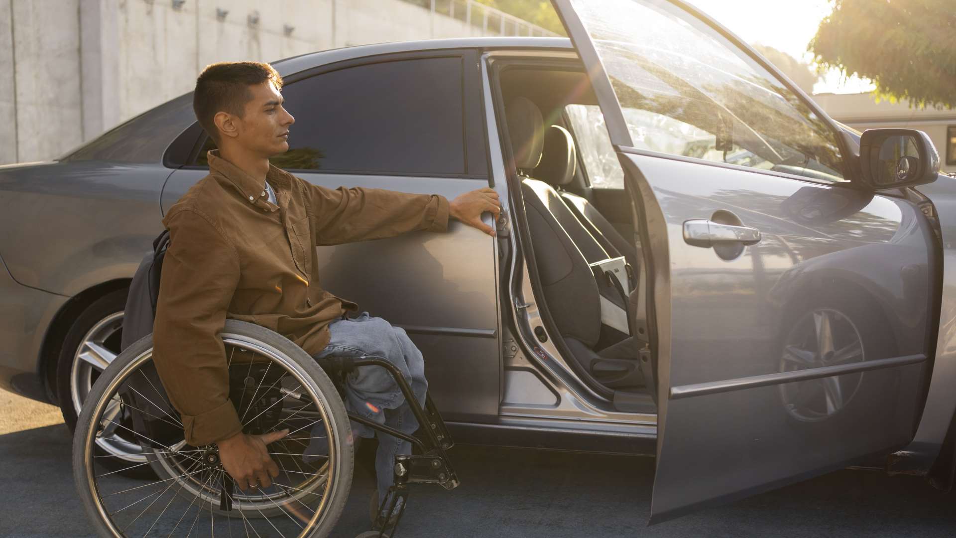 full shot man wheelchair near car