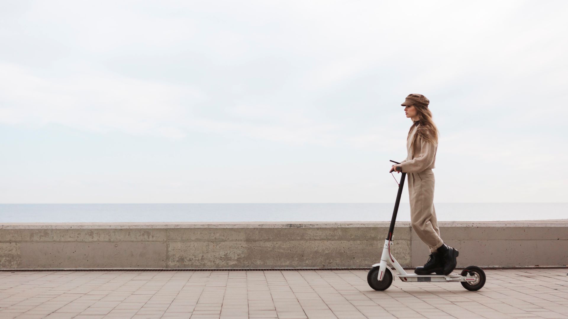 young woman riding electric scooter